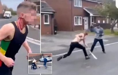 Horrific moment two bloodied men attack each other with machetes