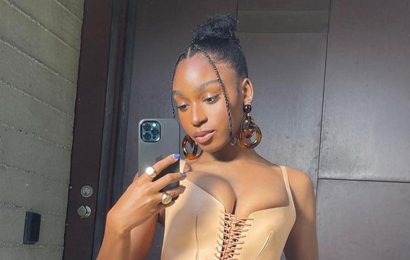 Normani is all laced up in a leather corset and barely-there skirt