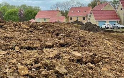 Locals fear 8ft pile of mud could mean burglars target their homes as walkers peer into homes from 'eyesore' mound