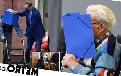 Cowardly Nazi guard, 100, covers his face as he's finally brought to trial