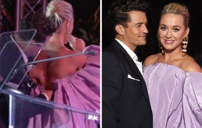 Katy Perry's fiancé Orlando Bloom rushes up to stage to undo singer's corset after she reveals she couldn't breathe