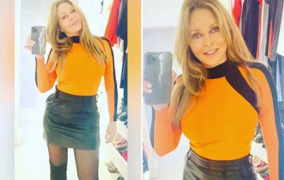 Carol Vorderman wows in a mini skirt and tight tangerine top as she hosts radio show