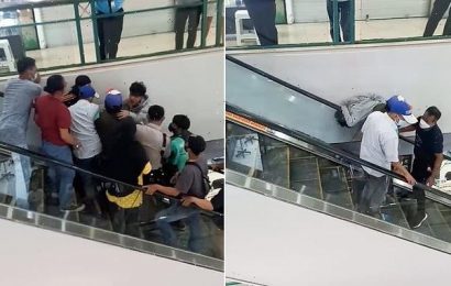 Shop worker gets his HEAD stuck in an escalator at Indonesian mall