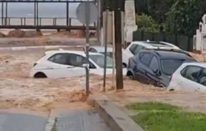 Dramatic moment cars are washed down road in Spain as map shows Brit holiday hotspots hit by horror floods | The Sun