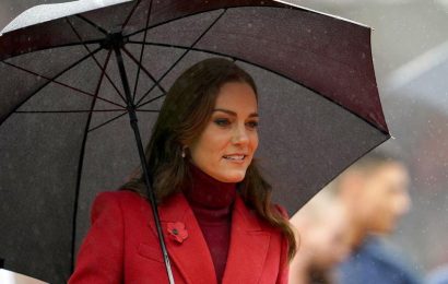 Kate Middleton braves the wet weather in red coat at England’s Rugby League match