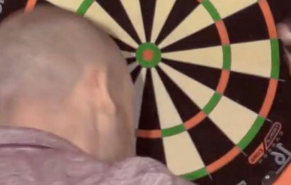 Darts star throws headbutt at board in frustration after surviving match dart