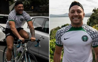 Conor McGregor back on his bike after being hit by car as he cycles in Nigeria kit then goes for dip in the sea | The Sun