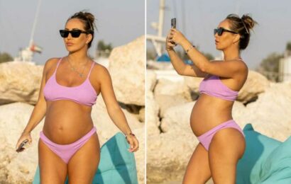 Lauryn Goodman looks incredible as she shows off baby bump in purple bikini in Dubai | The Sun
