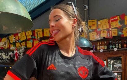 Man Utd's 'hottest fan' branded a 'stunning beauty' as she perches on a bar in Red Devils shirt and tiny shorts | The Sun