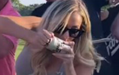 Paige Spiranac puts on very busty display in low-cut grey top as she slams a beer on the golf course | The Sun