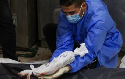 Doctor places body of an unborn child with its mother who died in Gaza