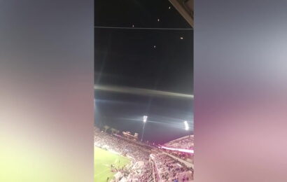 Mysterious glowing objects float in sky above football game in California